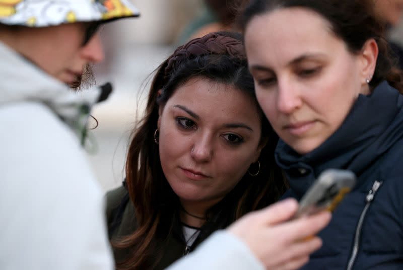 People gather outside Buckingham Palace in London