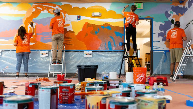 Left to right, Jasmin Apodaca, Xiangwei Zhang, Kara Gooding and Jeff Volante work on a paint-by-number mural at Freedom Landing in Salt Lake City on Wednesday.