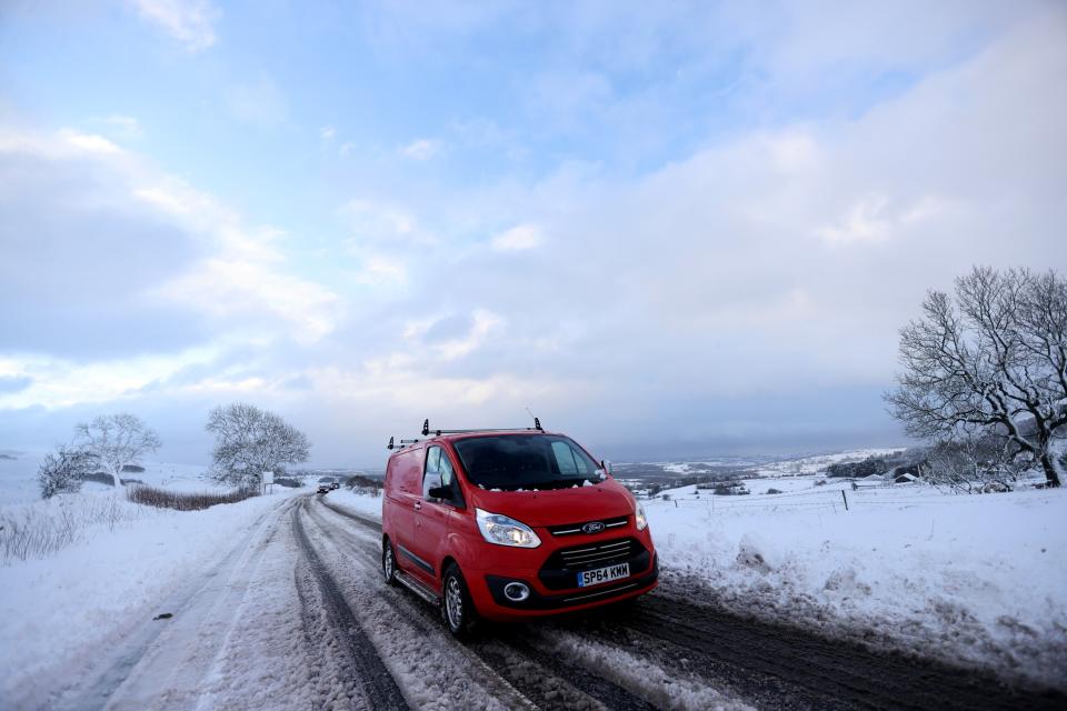 Cars are stuck in snow that fell overnight from Storm Arwen in Leek, Staffordshire. (REUTERS)