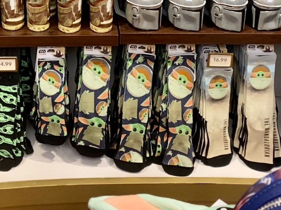 shelf of star wars socks in a store in disney world