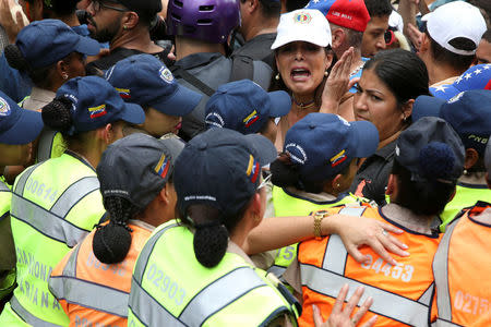 Opposition supporters argue with riot police during a rally against Venezuelan President Nicolas Maduro's government and to commemorate the 59th anniversary of the end of the dictatorship of Marcos Perez Jimenez in Caracas, Venezuela January 23, 2017. REUTERS/Carlos Garcia Rawlins