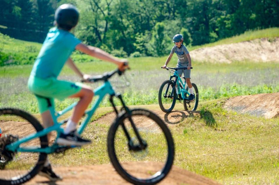 Austin Wilson, 11, watches his brother Easton Wilson, 11, as they try out the new dirt pump track at Bernel Road Park on Tuesday, May 21, 2024.