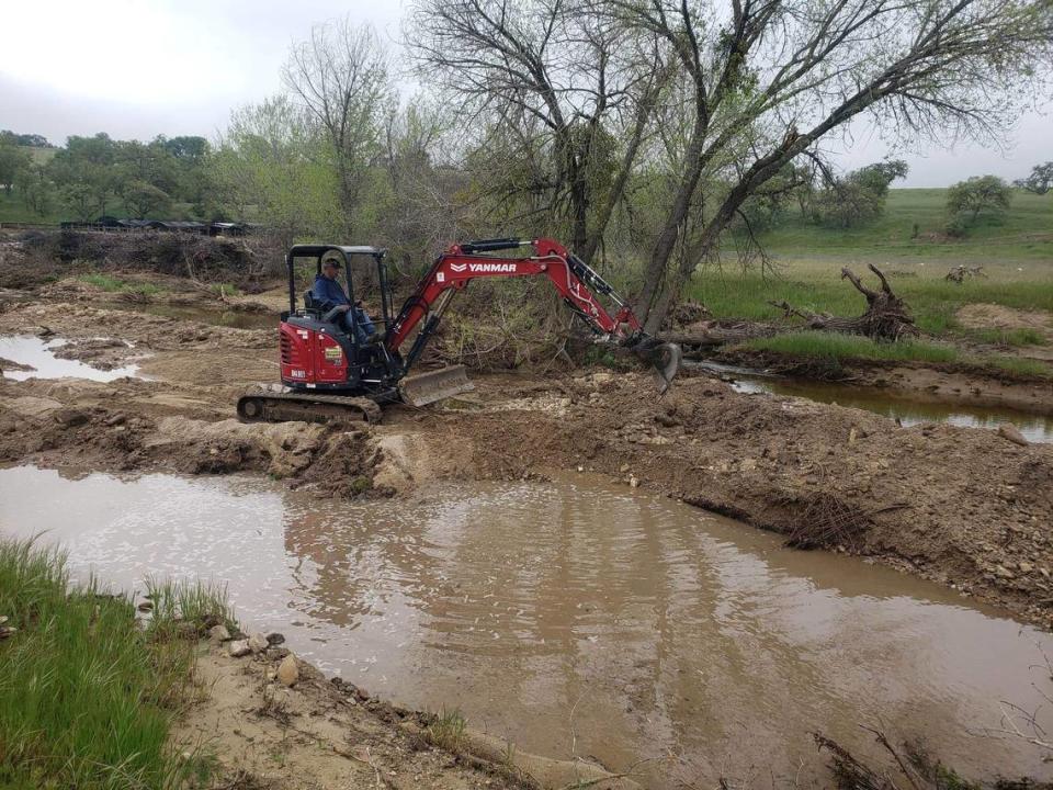 Volunteers operate heavy machinery at a part of San Marcos creek during an excavation to search for missing 5-year-old Kyle Doan on April 11.