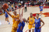 Southern California guard JuJu Watkins, shoots as UC Riverside guard Julia Stenberg, second from left, defends during the first half of an NCAA college basketball game Sunday, Dec. 10, 2023, in Los Angeles. (AP Photo/Mark J. Terrill)
