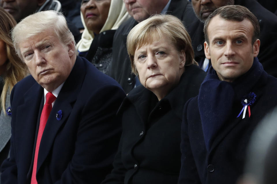 FILE - In this Nov.11, 2018 file photo, French President Emmanuel Macron, German Chancellor Angela Merkel and President Donald Trump attend a commemoration ceremony for Armistice Day, 100 years after the end of the First World War at the Arc de Triomphe in Paris, France. French President Emmanuel Macron hosts the G-7 summit this weekend fresh off a meeting with Russia's Vladimir Putin, hoping to maintain his image as a global mediator at a time of deep political and economic insecurity in the world and despite President Donald Trump's open disdain for multilateral talks. (Benoit Tessier/Pool Photo via AP)