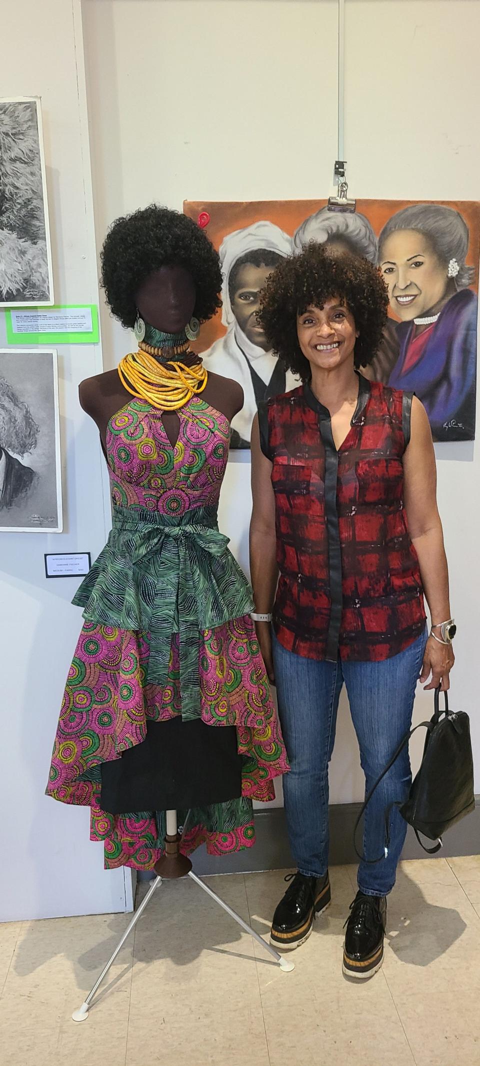 Damianne Fischer is seen here with her piece "African Elegant Dress". Fischer enjoys upcycling materials to make beautiful costumes.