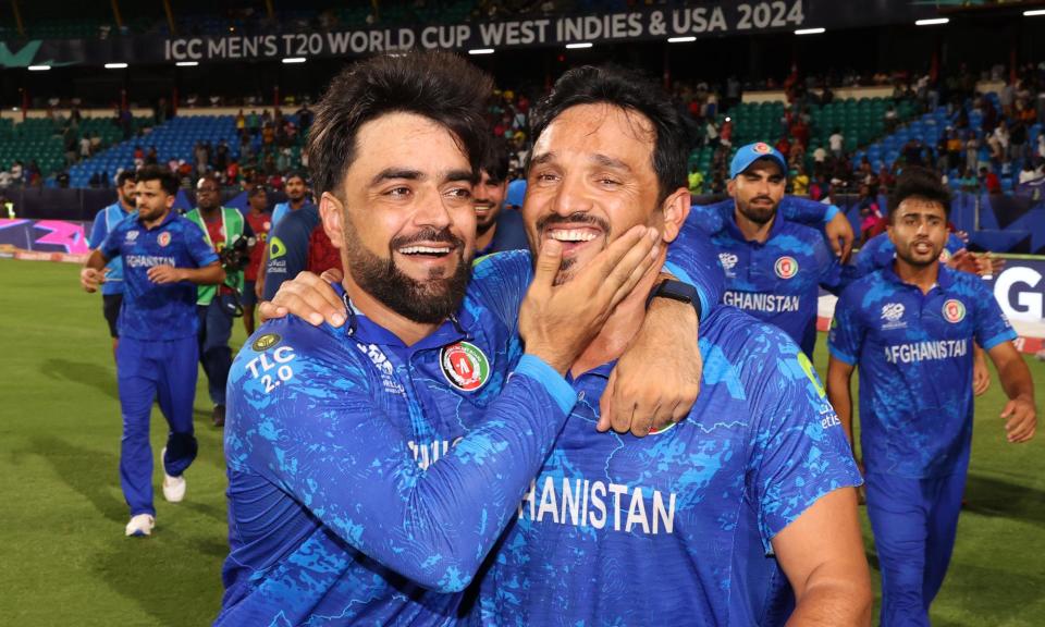 <span>Rashid Khan and Gulbadin Naib celebrate after Afghanistan’s victory.</span><span>Photograph: Darrian Traynor-ICC/ICC/Getty Images</span>