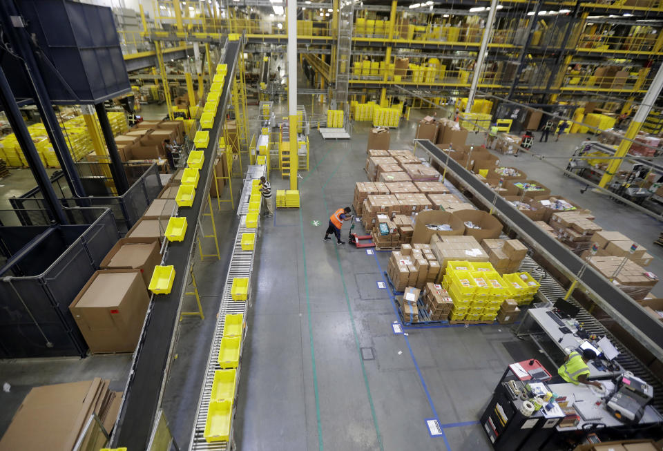 In this Tuesday, Aug. 1, 2017, photo, employees work at the Amazon Fulfillment center in Robbinsville Township, N.J. (AP Photo/Julio Cortez)