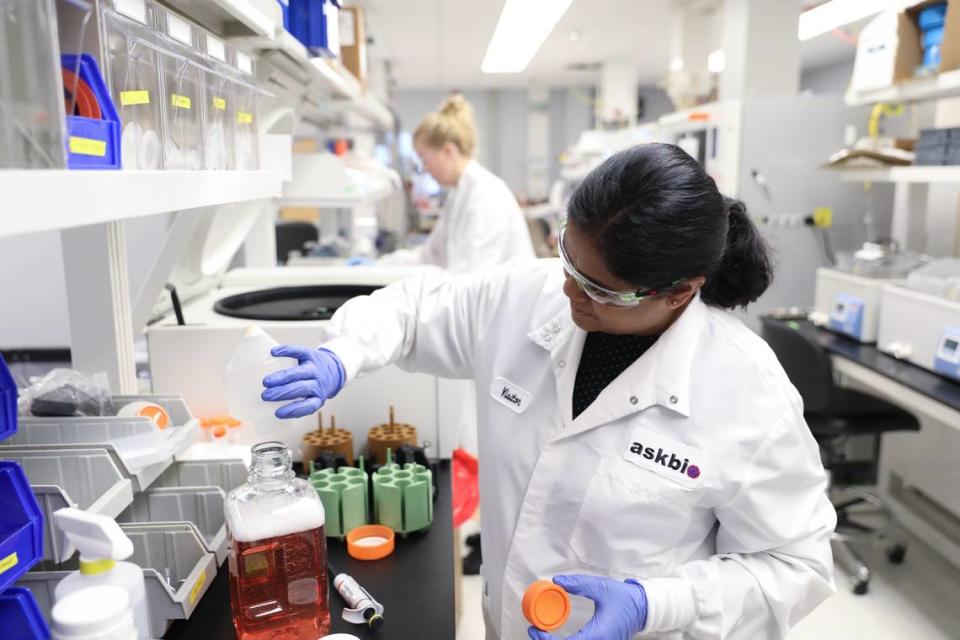 Scientists work in a lab at AskBio’s offices in Research Triangle Park.