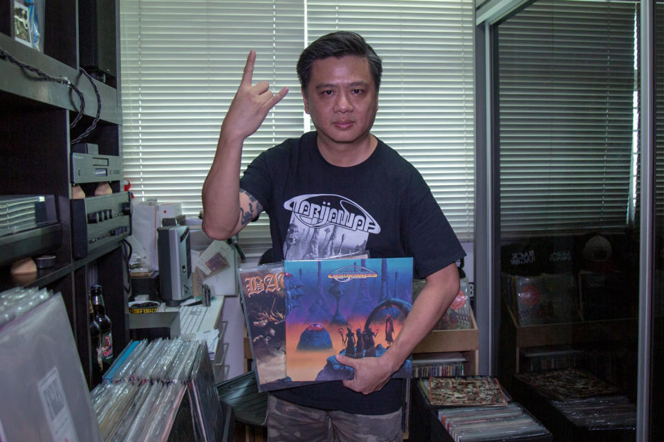 Foo showing off some of the vinyls in his large collection. (PHOTO: Dhany Osman / Yahoo News Singapore)
