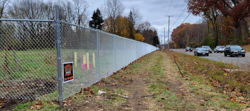 Thousands of cars pass the former Industrial Excess Landfill, a federal Superfund site, on a daily basis. This fence was moved closer to Cleveland Avenue NW when the old fence fell shy of the area where methane emissions are now being detected.