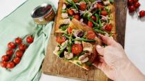 <p>We love a mash-up, and this one that combines a <a href="https://www.delish.com/cooking/recipe-ideas/a39564289/classic-nicoise-salad-recipe/" rel="nofollow noopener" target="_blank" data-ylk="slk:Niçoise salad;elm:context_link;itc:0;sec:content-canvas" class="link ">Niçoise salad</a> with <a href="https://www.delish.com/cooking/recipe-ideas/g269/homemade-pizza-recipes/" rel="nofollow noopener" target="_blank" data-ylk="slk:pizza;elm:context_link;itc:0;sec:content-canvas" class="link ">pizza</a> is one of our faves. Start with a store-bought or homemade <a href="https://www.delish.com/cooking/recipe-ideas/a24794273/easy-pizza-dough-recipe/" rel="nofollow noopener" target="_blank" data-ylk="slk:pizza dough;elm:context_link;itc:0;sec:content-canvas" class="link ">pizza dough</a>, then layer on thinly sliced <a href="https://www.delish.com/cooking/recipe-ideas/g3030/potato-recipes/" rel="nofollow noopener" target="_blank" data-ylk="slk:potatoes;elm:context_link;itc:0;sec:content-canvas" class="link ">potatoes</a> before baking. Once it’s golden and cooled slightly, go to town with all the fixings: peppery arugula, bright green beans, sweet tomatoes, salty olives, crisp red onions, and rich, savory chunks of canned tuna. Yum!</p><p>Get the <strong><a href="https://www.delish.com/cooking/recipe-ideas/a36451070/pizza-nicoise-recipe/" rel="nofollow noopener" target="_blank" data-ylk="slk:Pizza Niçoise recipe;elm:context_link;itc:0;sec:content-canvas" class="link ">Pizza Niçoise recipe</a></strong>.</p>