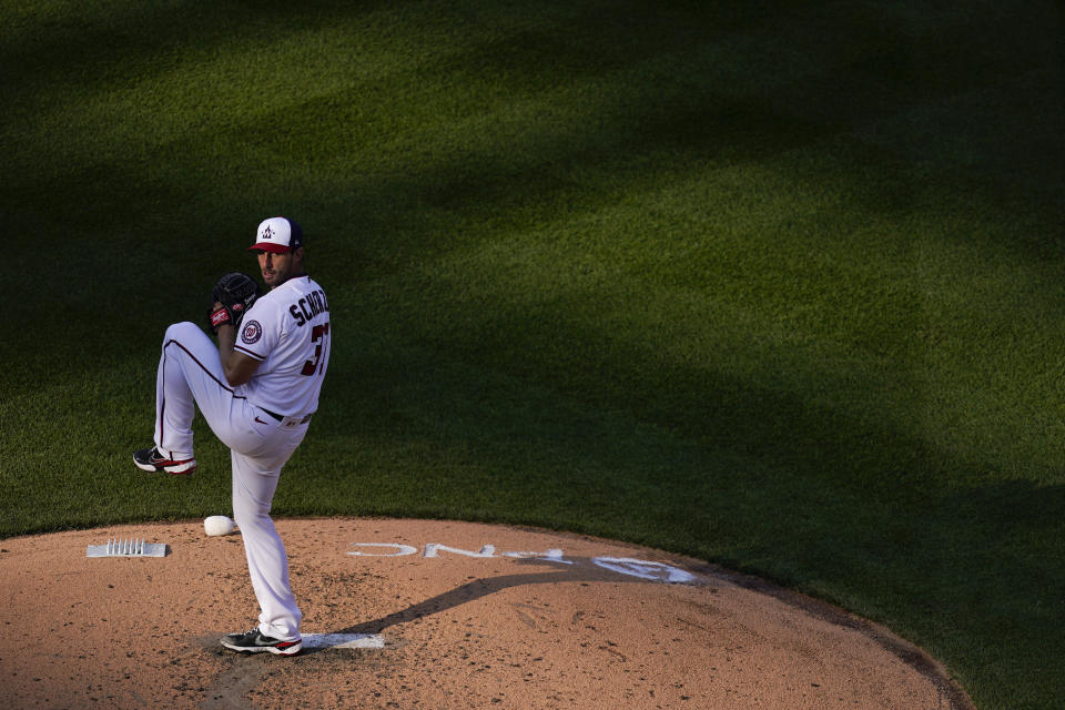 Washington Nationals starting pitcher Max Scherzer throws to the Atlanta Braves in the sixth inning of an opening day baseball game at Nationals Park, Tuesday, April 6, 2021, in Washington. (AP Photo/Alex Brandon)