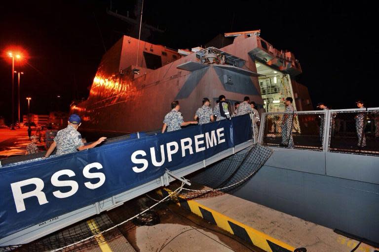 Republic of Singapore Navy servicemen board the Formidable-class frigate RSS Supreme before departing for Indonesia to take part in the search for missing AirAsia Flight QZ8501