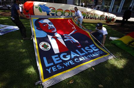 Members of the Help End Marijuana Prohibition (HEMP) Party lift a banner displaying a parody of U.S. President Barack Obama's election campaign poster with the slogan "Legalise - Yes We Can-Nabis" written underneath, during their 2013 National Election Campaign launch in central Sydney September 2, 2013. REUTERS/David Gray