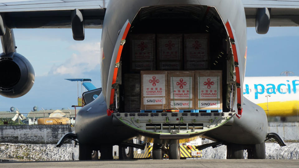 In this photo provided by the Presidential Communications Operations Office-Office of the Global Media Public Affairs, a Chinese military plane carrying the first batch of Sinovac vaccine from China arrives at the Villamor Air Base in Manila, Philippines on Sunday Feb. 28, 2021. The Philippines is due to receive its first batch of COVID-19 vaccine Sunday, among the last in Southeast Asia to secure the critical doses despite having the second-highest number of coronavirus infections and deaths in the hard-hit region. (PCOO-OGMPA via AP)