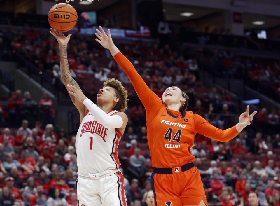 Ohio State guard Rikki Harris, left, shoots in front of Illinois forward Kendall Bostic during the second half of an NCAA college basketball game in Columbus, Ohio, Sunday, Jan. 8, 2023. (AP Photo/Paul Vernon)