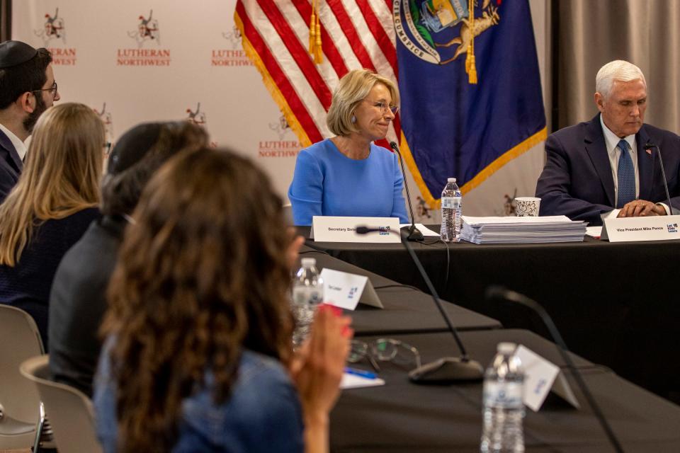 Former United States Secretary of Education Betsy DeVos, left and former Vice President of the United States Mike Pence, right, speak during a roundtable to discuss a proposal to provide educational scholarships to Michigan students at Lutheran North High School in Rochester Hills on Tuesday, May 17, 2022.