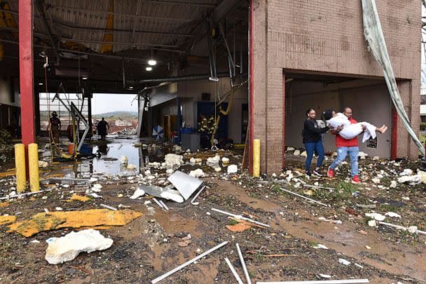 PHOTO: A woman is carried out of a fire station to an ambulance after a tornado tore through west Little Rock, Ark., on March 31, 2023. (Staci Vandagriff/Arkansas Democrat-Gazette via AP)