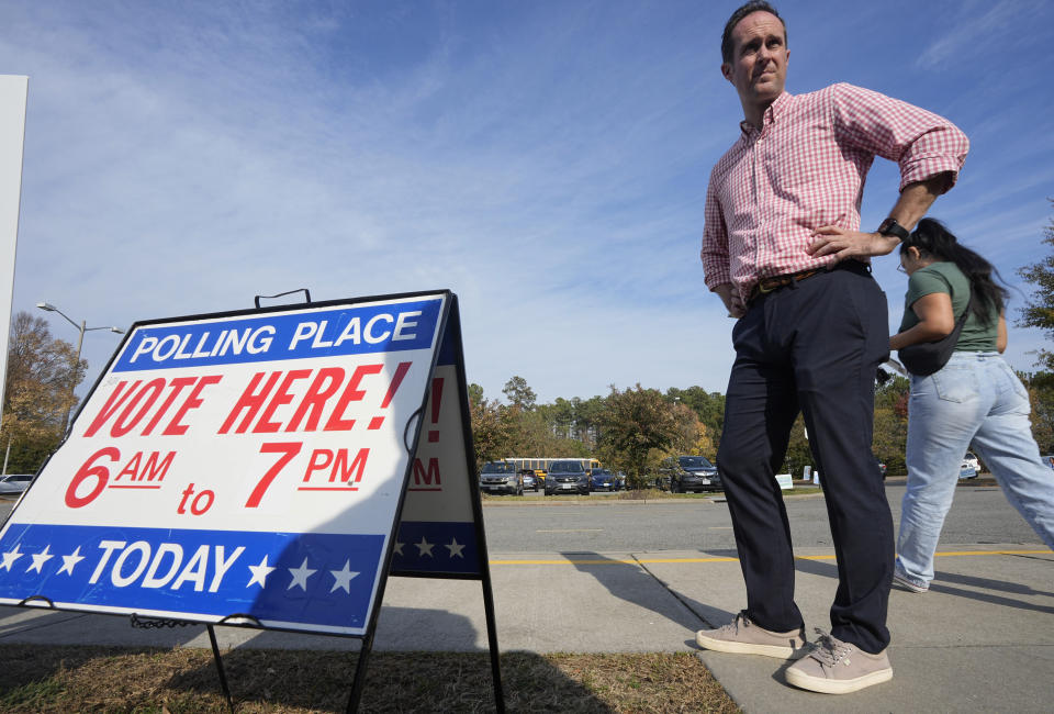 Del. Schuyler VanValkenburg, D-Henrico, waits for voters at an elementary school polling station Tuesday Nov. 7, 2023, in Glenn Allen, Va. VanValkenburg is challenging Republican State Sen. Siobhan Dunnavant R-Henrico in Tuesday's election. (AP Photo/Steve Helber)