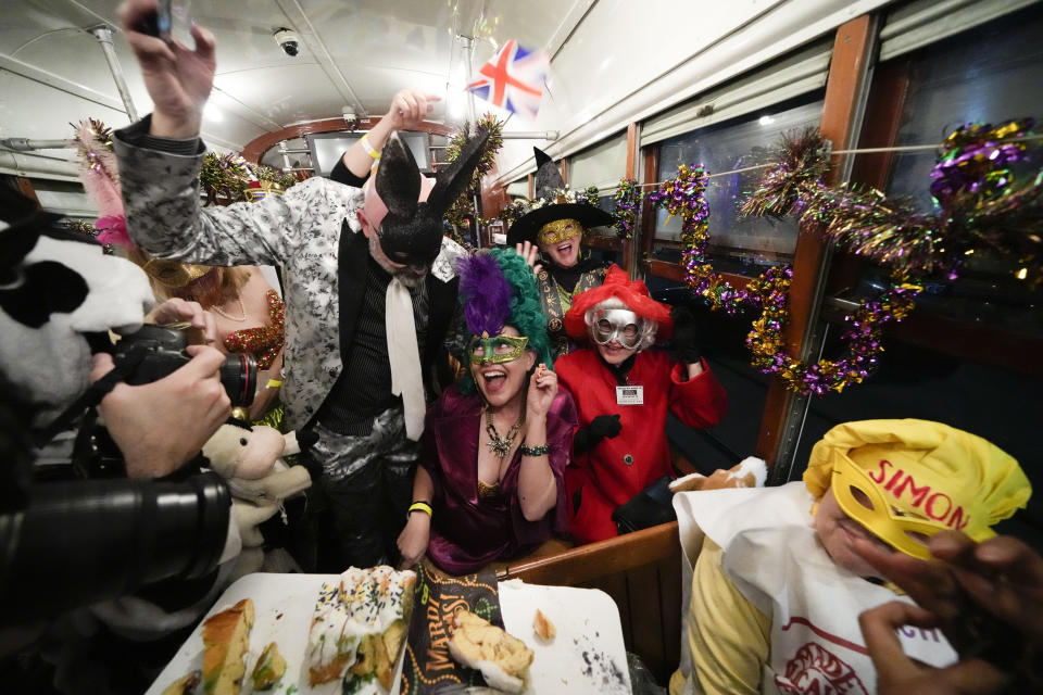 Members of the Mardi Gras group The Phunny Phorty Phellows revel on a street car for their annual kick off of the Mardi Gras season on Twelfth Night in New Orleans, Friday, Jan. 6, 2023. (AP Photo/Gerald Herbert)