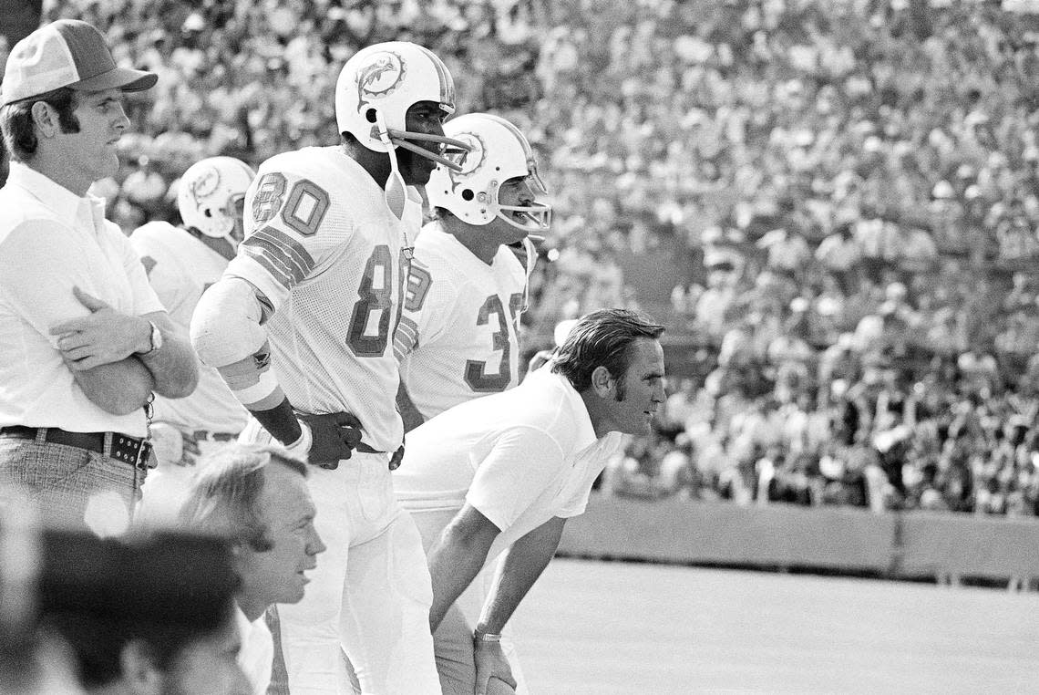 Miami Dolphin Coach Don Shula leans forward in concentration as he watches his team deliver a 52-0 win over the New England Patriots on Sunday, Nov. 12, 1972 at Miami?s Orange Bowl for his 100th victory. Shula thus became the first NFL coach to win 100 games in his first 10 seasons. With him are Marv Fleming (80) and Larry Csonka (39).