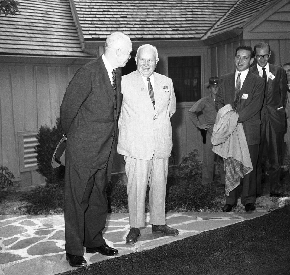 President Dwight D. Eisenhower and Soviet Premier Khrushchev pose for photos outside the main lodge at the presidential retreat at Camp David on Sept. 25, 1959, in Thurmont, Md.