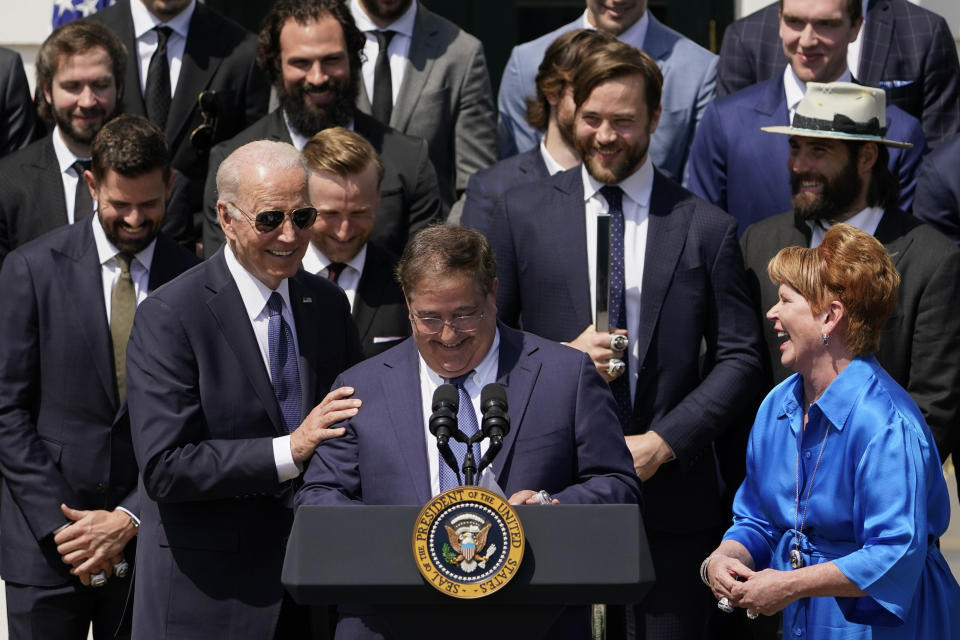 President Joe Biden smiles as owner Jeff Vinik speaks during an event to celebrate the Tampa Bay Lightning's 2020 and 2021 Stanley Cup championships at the White House, Monday, April 25, 2022, in Washington. At right is Penny Vinik. (AP Photo/Andrew Harnik)