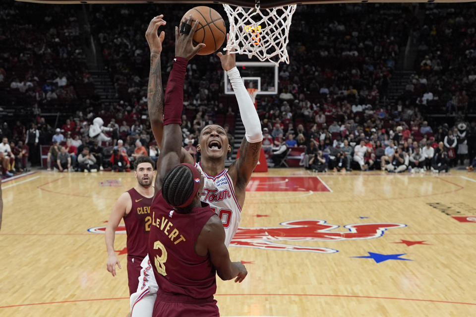 Houston Rockets' Jabari Smith Jr. (10) has his shot blocked by Cleveland Cavaliers' Caris LeVert (3) during the first half of an NBA basketball game Saturday, March 16, 2024, in Houston. (AP Photo/David J. Phillip)