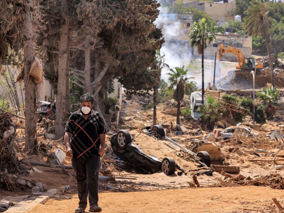 A view of a man walking among a destroyed building in Libya's eastern city of Derna.