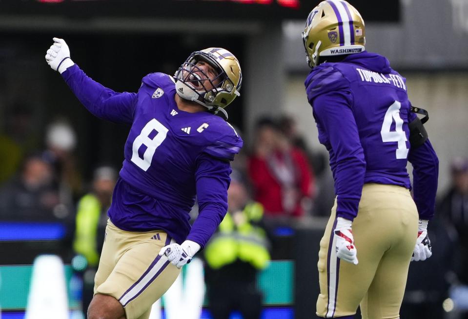 Washington defensive end Bralen Trice (8) celebrates a sack against Utah as defensive end Zion Tupuola-Fetui (4) looks on during the first half of an NCAA college football game Saturday, Nov. 11, 2023, in Seattle. | Lindsey Wasson, Associated Press