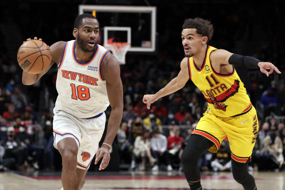 New York Knicks guard Alec Burks (18) dribbles around Atlanta Hawks guard Trae Young (11) as he goes to the basket during the second half of an NBA basketball game Saturday, Jan. 15, 2022, in Atlanta. (AP Photo/Butch Dill)