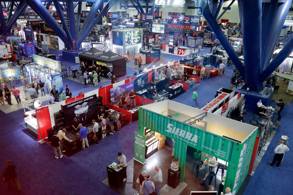 Visitors mill about the exhibitors booths in the main exhibition hall at the National Rifle Association Annual Meeting at the George R. Brown Convention Center, Friday, May 27, 2022, in Houston. (AP Photo/Michael Wyke) ORG XMIT: TXMW101