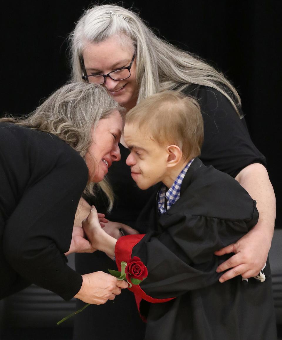 Gabriel Magruder gives his crying mother, Julie Callahan, a rose during the North Shelby Graduation Ceremony held Thursday morning, May 11, 2023, in the gym at North Shelby School.