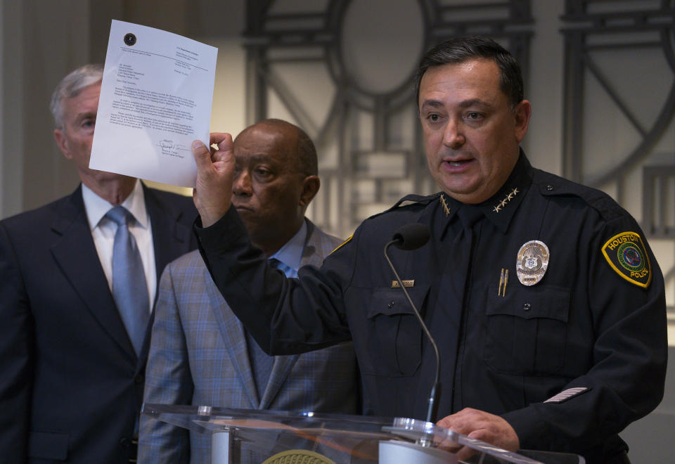 Houston Police Department Chief Art Acevedo holds up a letter from the FBI announcing the bureau's civil rights investigation related to the deaths of two people during the no-knock raid by narcotics officers that killed two people and injured five police officers last month, during a press conference from Houston City Hall, Wednesday, Feb. 20, 2019.