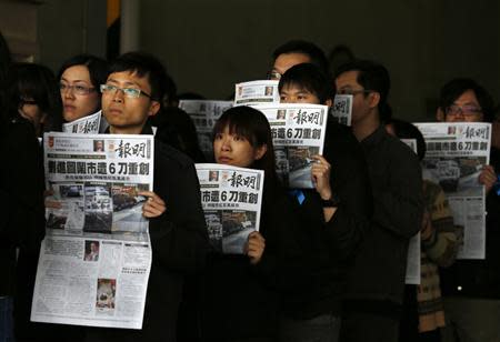 Journalists and editors from Ming Pao hold up front pages of their newspaper during a protest against violence in Hong Kong February 27, 2014, after Wednesday's attack on their former chief editor Kevin Lau. REUTERS/Bobby Yip