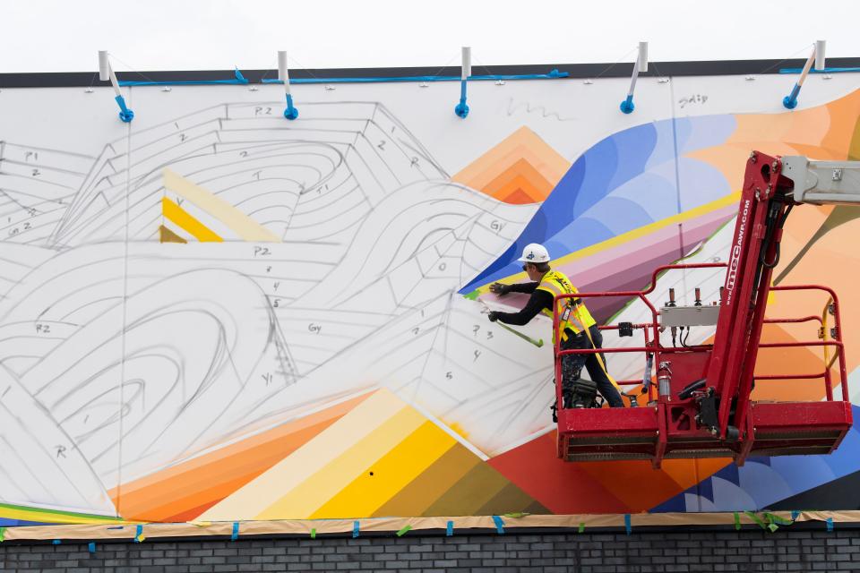 Nathan Brown, a local artist from Tennessee works on the Mural at Tanger Factory Outlets in Antioch, Tenn., Thursday, Oct. 5, 2023. The grand opening will be on Oct. 27, 2023