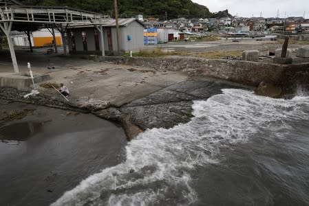 A man is seen at an area for landing captured whales at Wada fishing port in Minamiboso