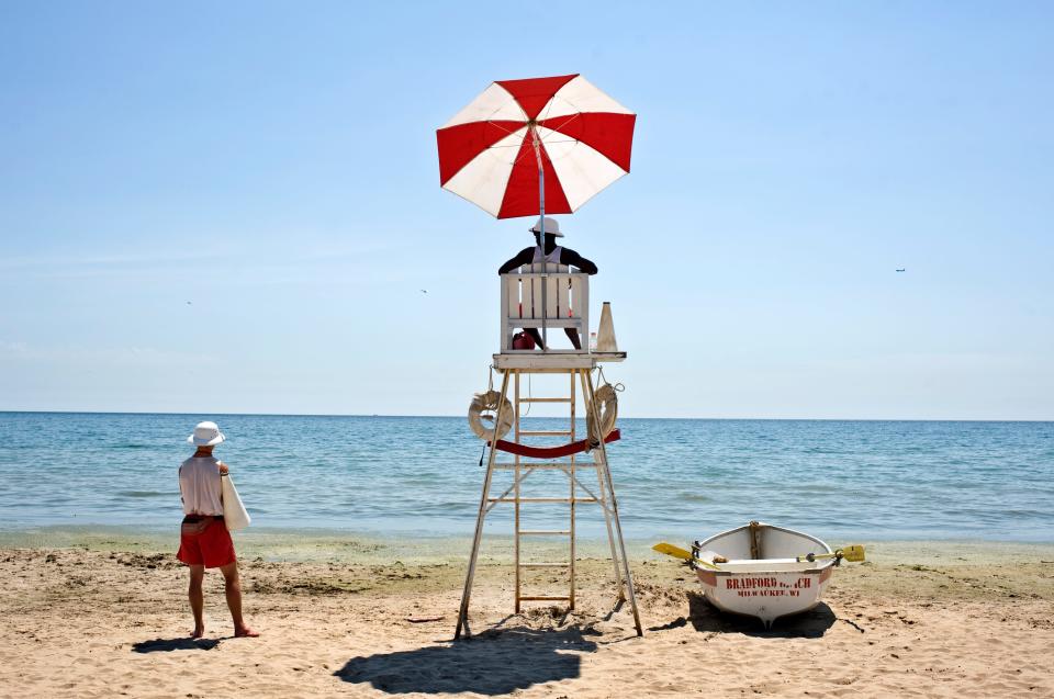 Lifeguards Nathaniel Scharping (left) and Lance Dorsey watch over Lake Michigan at Bradford Beach.