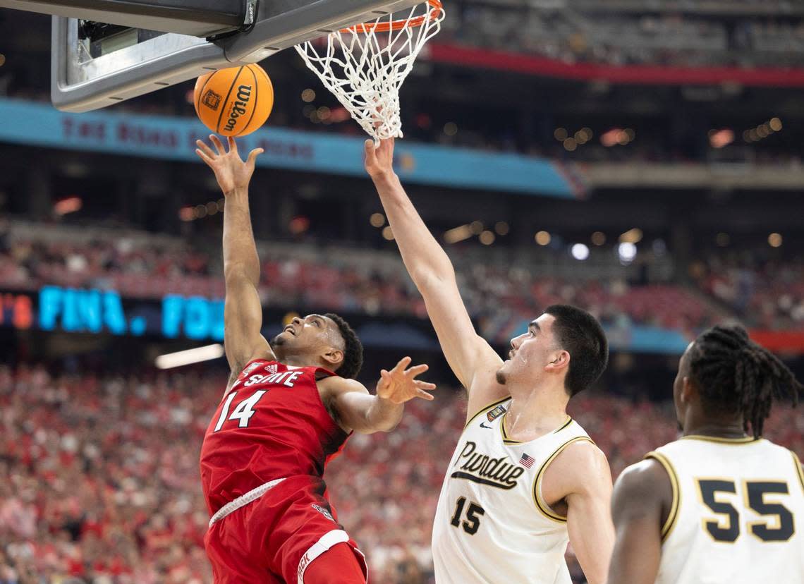 N.C. Casey Morsell (14) drives to the basket against Purdue’s Zach Edey (15) during the first half in the NCAA Final Four National Semifinal game on Saturday, April 6, 2024 at State Farm Stadium in Glendale, AZ. Robert Willett/rwillett@newsobserver.com