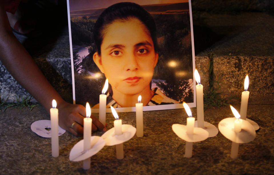 A student of a nursing college places a candle in front of a picture depicting nurse Jacintha Saldanha, during a candle-lit vigil organized by a local politician in Bangalore, India, Thursday, Dec. 13, 2012. An inquest into the apparent suicide of Saldanha, who was duped by a hoax call from Australian DJs about the pregnant Duchess of Cambridge, heard Thursday that she was found hanging in her room, had wrist injuries and left three notes. (AP Photo/Aijaz Rahi)