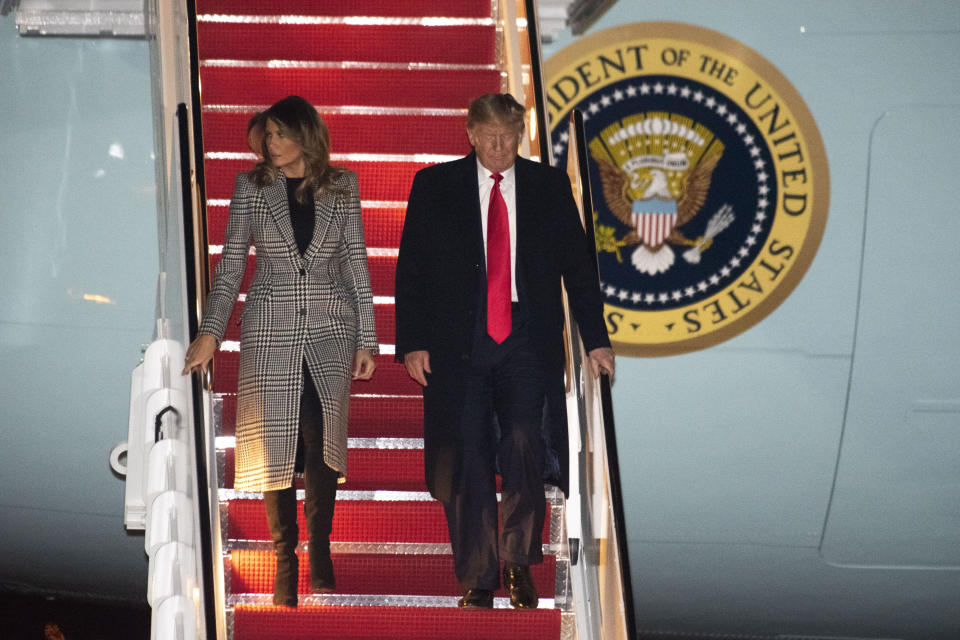President Donald Trump and first lady Melania Trump arrive on Air Force One on Wednesday, Dec. 4, 2019, at Andrews Air Force Base, Md., following a trip to the NATO Summit in England. (AP Photo/Kevin Wolf)
