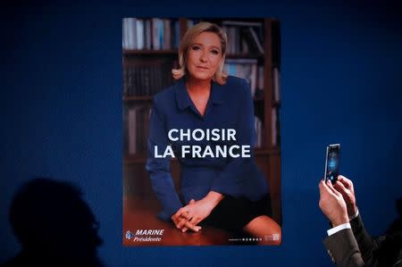 The poster with a new second round campaign slogan "Choose France" for Marine Le Pen, French National Front (FN) political party candidate for French 2017 presidential election is presented during a news conference in Paris, France, April 26, 2017. REUTERS/Christian Hartmann