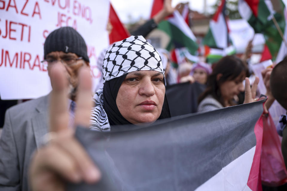 A woman shows a peace sign during a protest against Israel and in support of Palestinians in Sarajevo, Bosnia, Sunday, Oct. 22, 2023. (AP Photo/Armin Durgut)