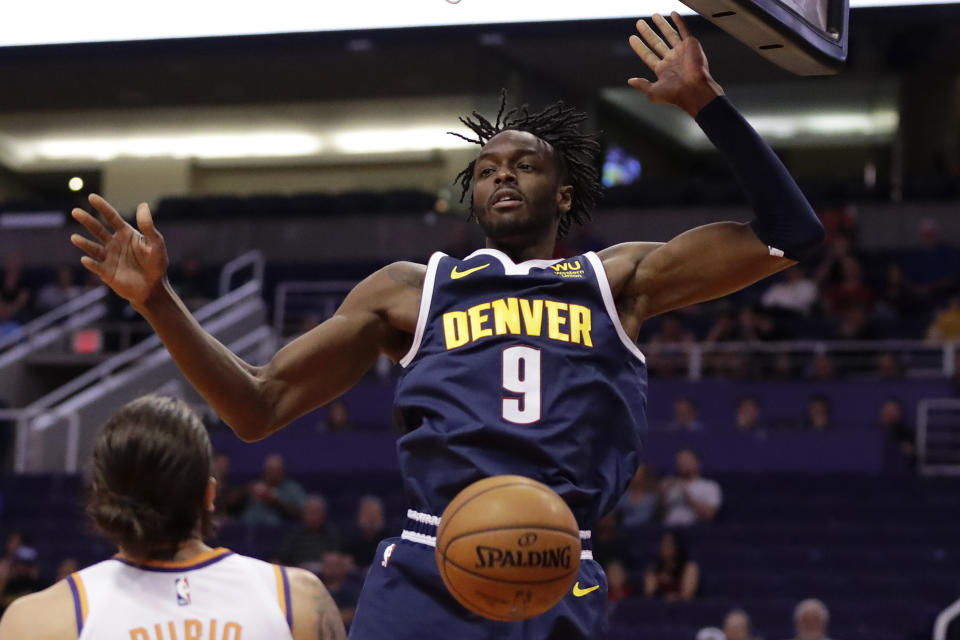 Denver Nuggets forward Jerami Grant (9) dunks against the Phoenix Suns during the first half of an NBA preseason basketball game, Monday, Oct. 14, 2019, in Phoenix. (AP Photo/Matt York)