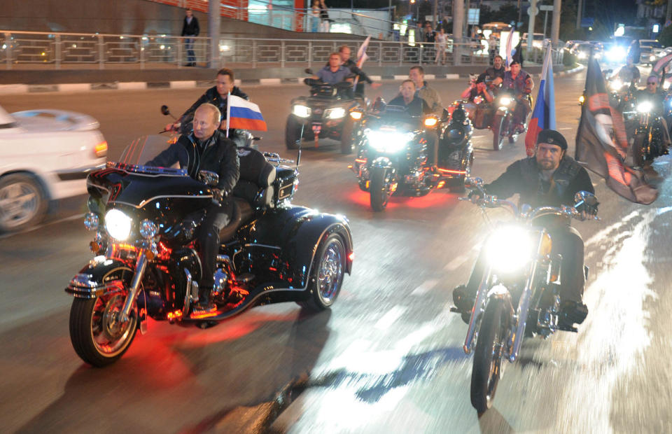 then Russian Prime Minister Vladimir Putin, center left, and leader of Nochniye Volki (the Night Wolves) biker group, Alexander Zaldostanov, also known as Khirurg (the Surgeon), right, ride bikes at a motor bikers' festival in the Black Sea port of Novorossiysk, Russia. Putin has become alternately notorious and beloved for an array of adventurous stunts, including posing with a tiger cub and riding a horse bare-chested. (AP Photo/RIA Novosti, Alexei Druzhinin, POOL, file)