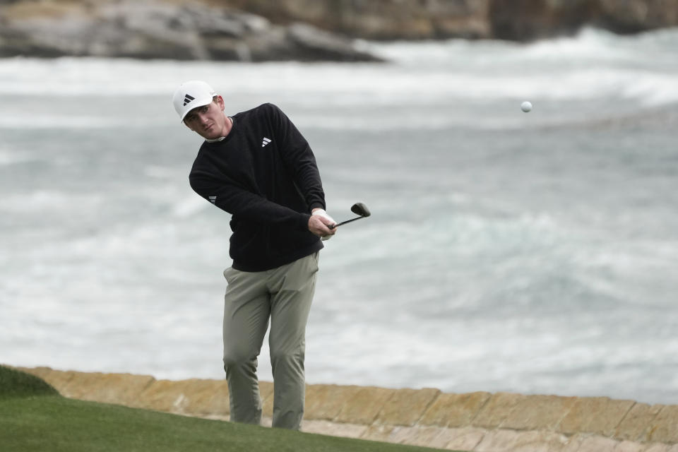 Nick Dunlap chips the ball up to the 18th green of the Pebble Beach Golf Links during a practice round of the AT&T Pebble Beach National Pro-Am golf tournament in Pebble Beach , Calif., Wednesday, Jan. 31, 2024. (AP Photo/Eric Risberg)