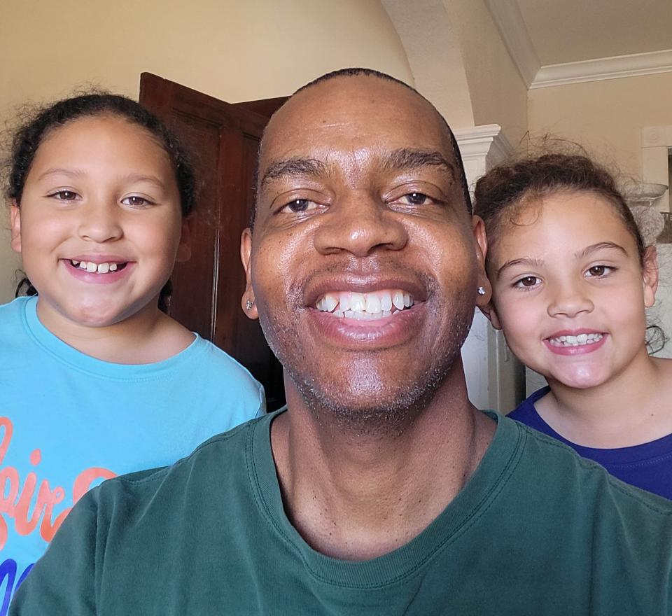 Kevin Ford with his granddaughters Charlotte May (left) and Claralyn May (right).