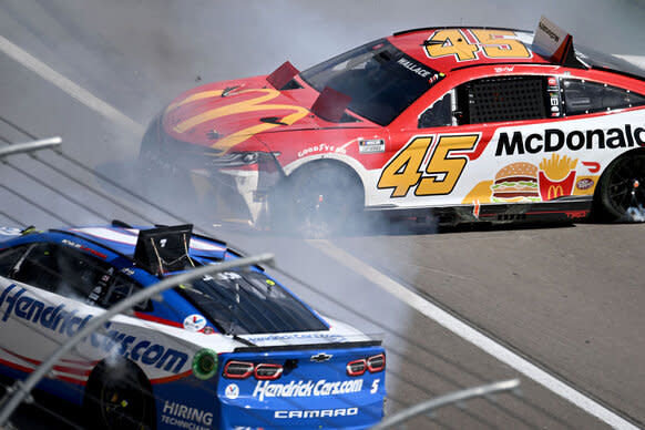 Bubba Wallace (#45 23XI Racing MoneyLion Toyota), rear, and Kyle Larson (#5 Hendrick Motorsports HendrickCars.com Chevrolet), front, crash on the front straight away during the NASCAR Cup Series Playoff South Point 400