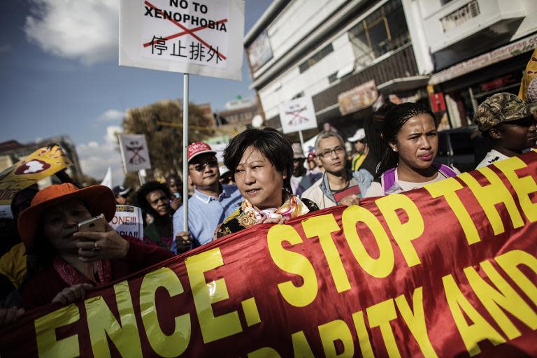 People participate in a protest march against the recent wave of xenophobic attacks in South Africa through the streets of Johannesburg on April 23, 2015